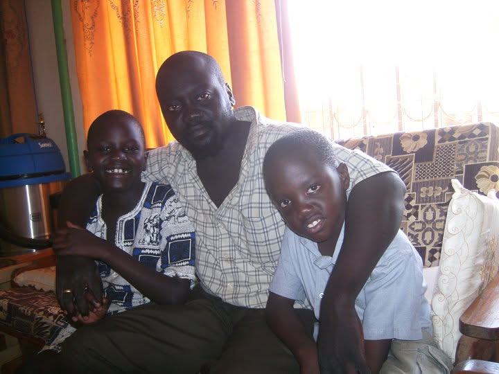 Libo and Lemi seated closely with their uncle Labana