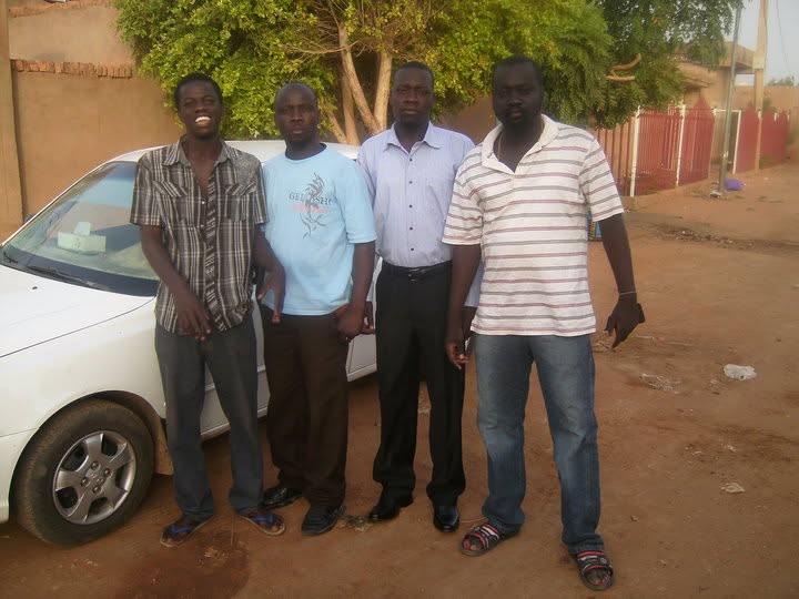 Salah Taltala, George, Matayo and Labanese standing beside a car