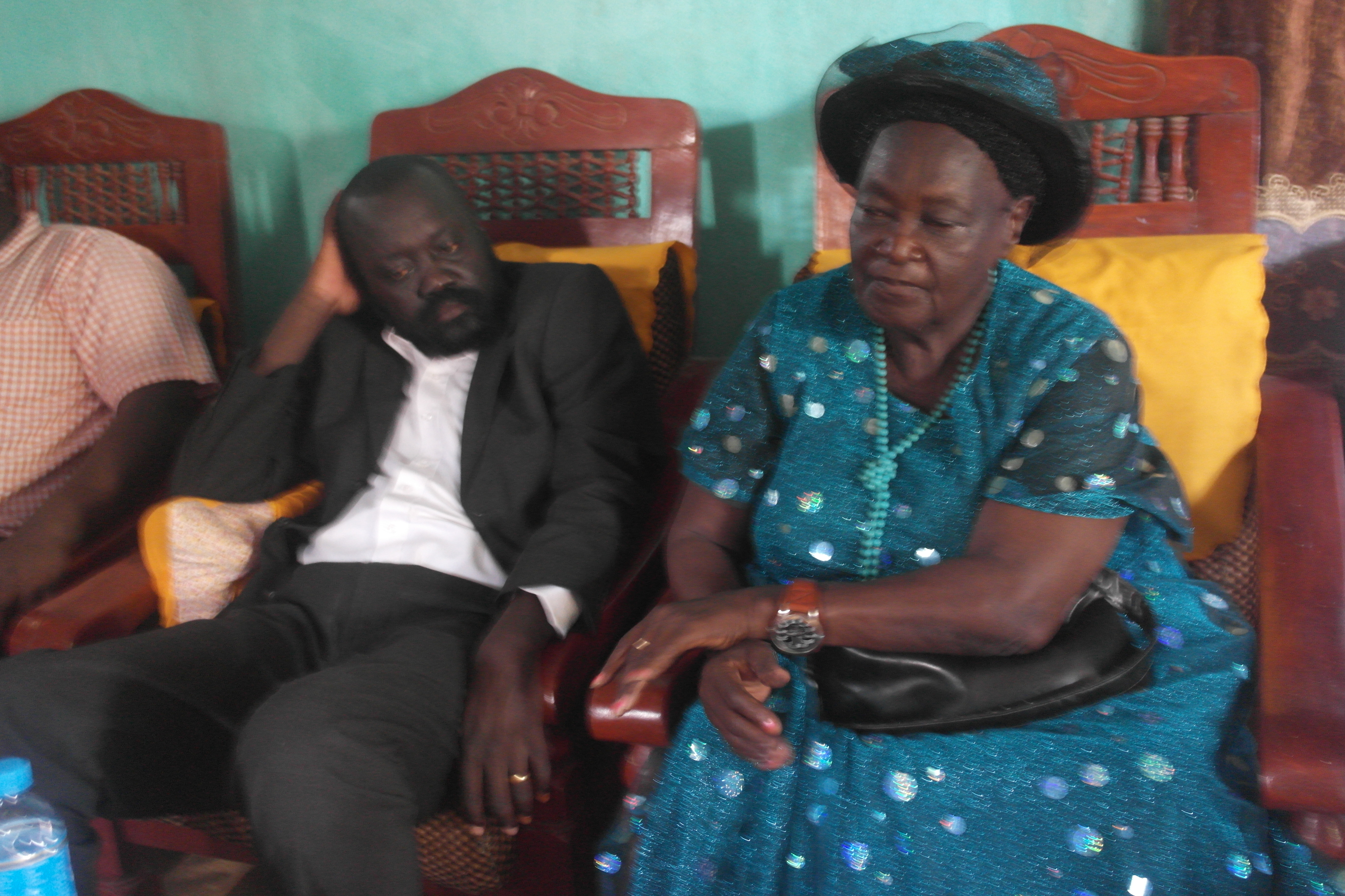 Labana seated beside a woman at a family gathering