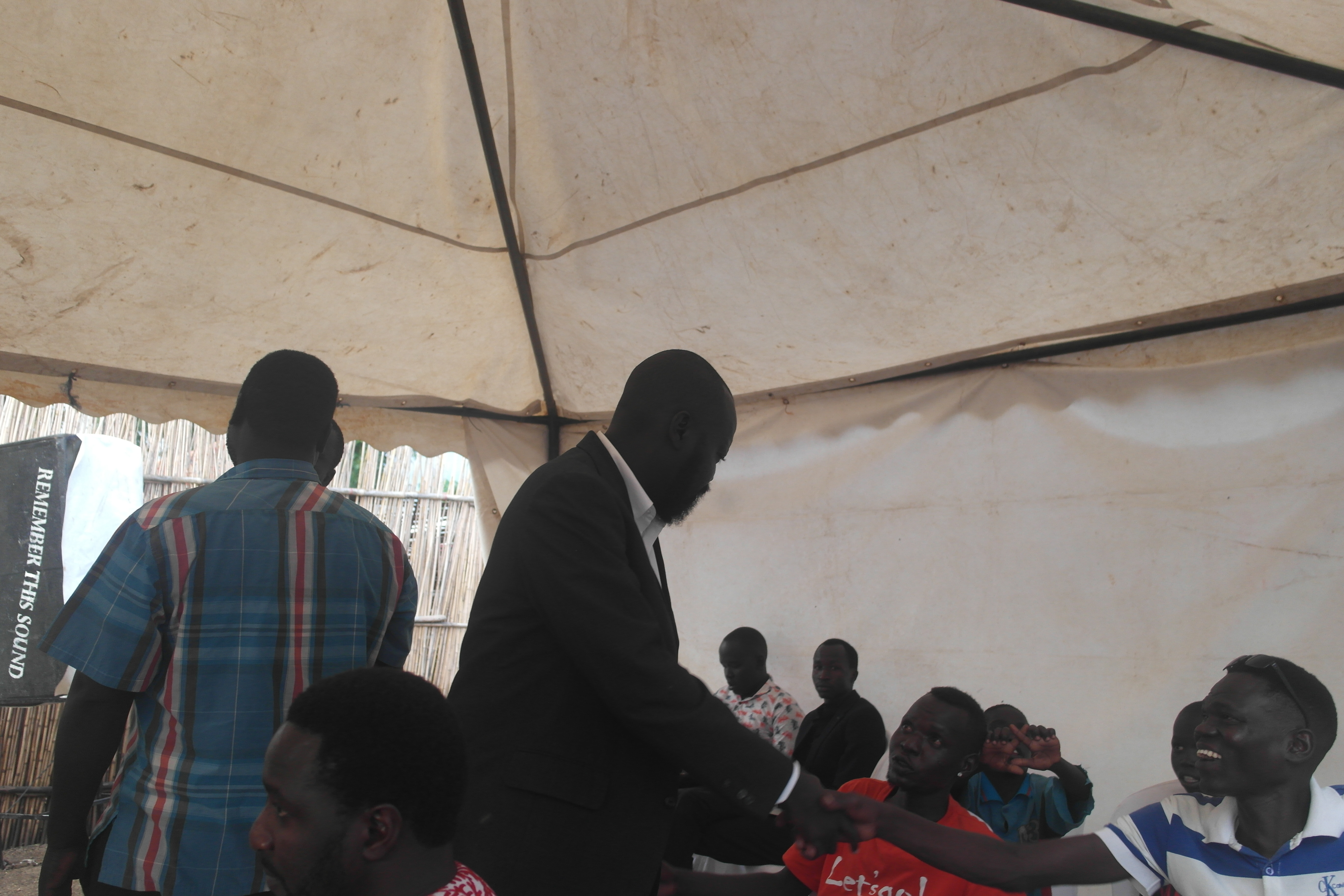 Labana greeting guests beneath a marquee